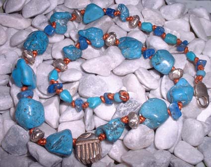 turquoise and siver beads with silver scrab on  copper leather thong 